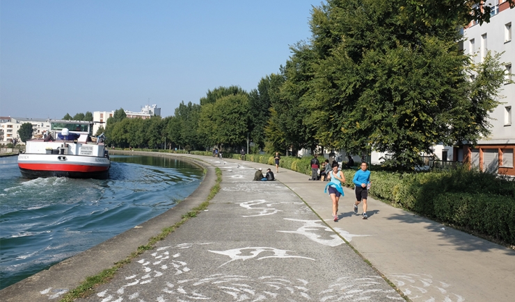 People relaxing and jogging alongside the Saint-Denis Canal, by the bend - Boucle du Cornillon @ Apur
